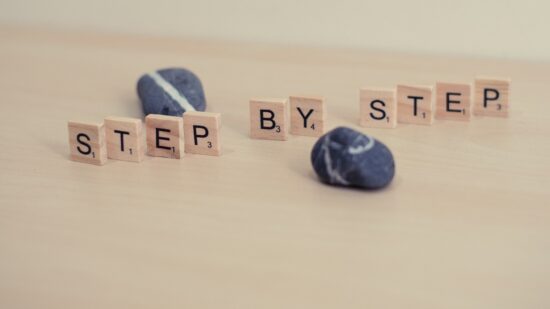 Step by step, wooden letter photography. Wood and stones. Progress